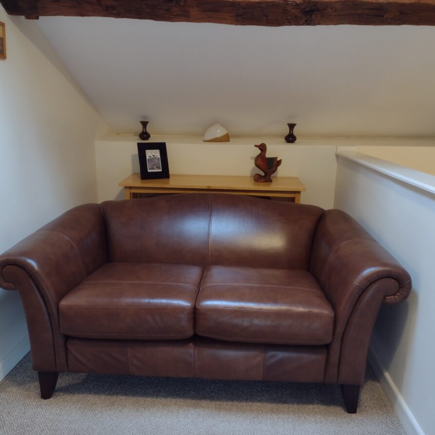 A comfy leather sofa and roof windows in the upstairs bedroom.